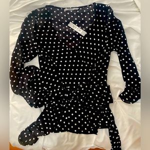 Beautiful black and white polka dotted blouse with flared ruffle on arms!